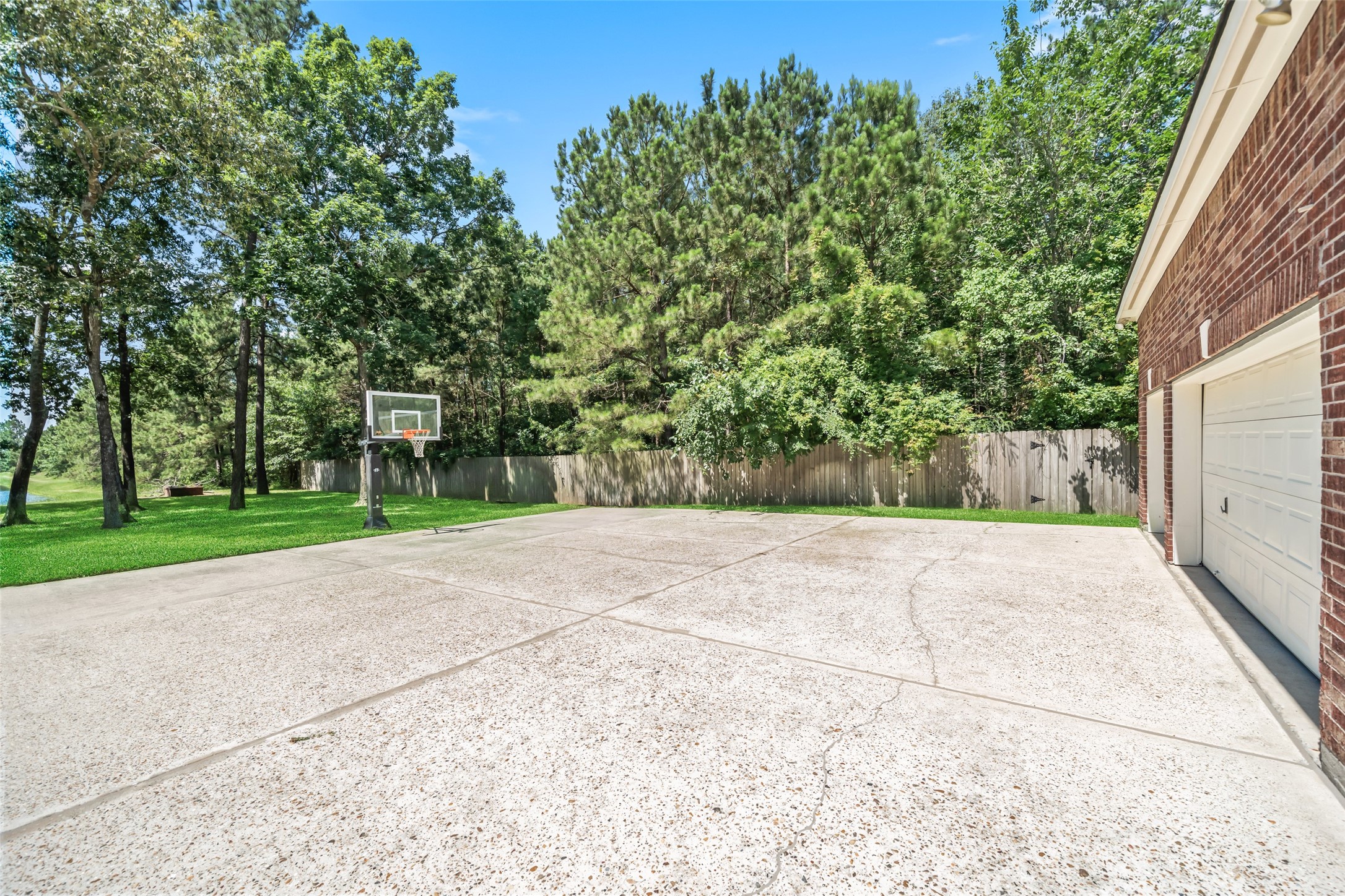 2302 Legends Shore Drive Spring, TX 77386 - Photo 26 of 48 Spacious paved area ideal for recreation, gatherings, or outdoor activities.