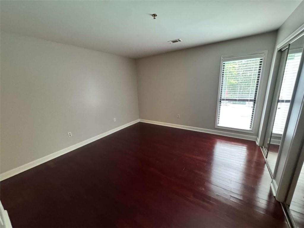 3201 Lenox Road Northeast, Unit 2 Atlanta, GA 30324 - Photo 11 of 39 an empty room with wooden floor and windows