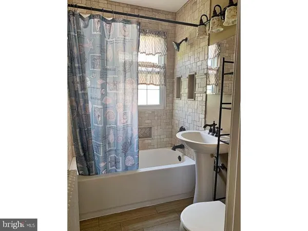 a bathroom with a tub and shower