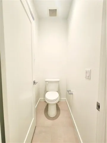 a white toilet sitting next to a white sink