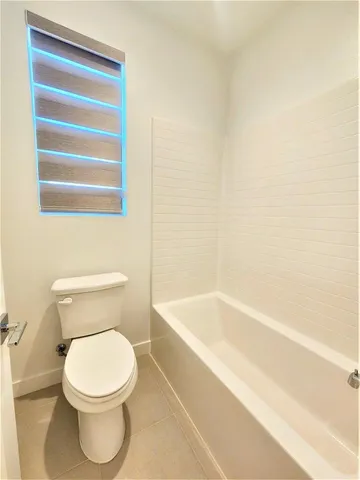 a bathroom with a toilet and a bathtub