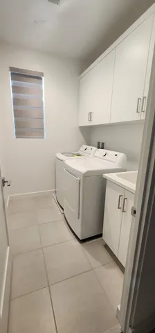 a utility room with a sink a washer and dryer