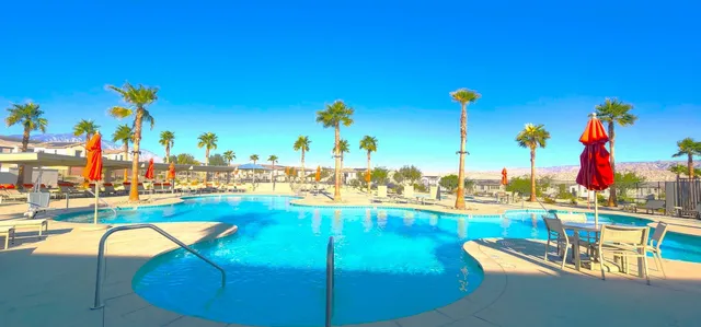 a view of a swimming pool with outdoor seating