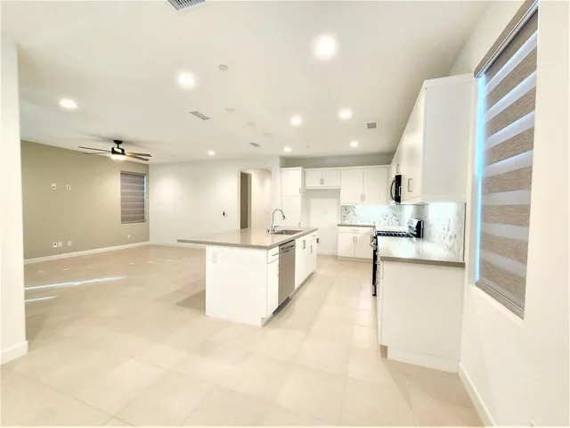 a large white kitchen with a large window
