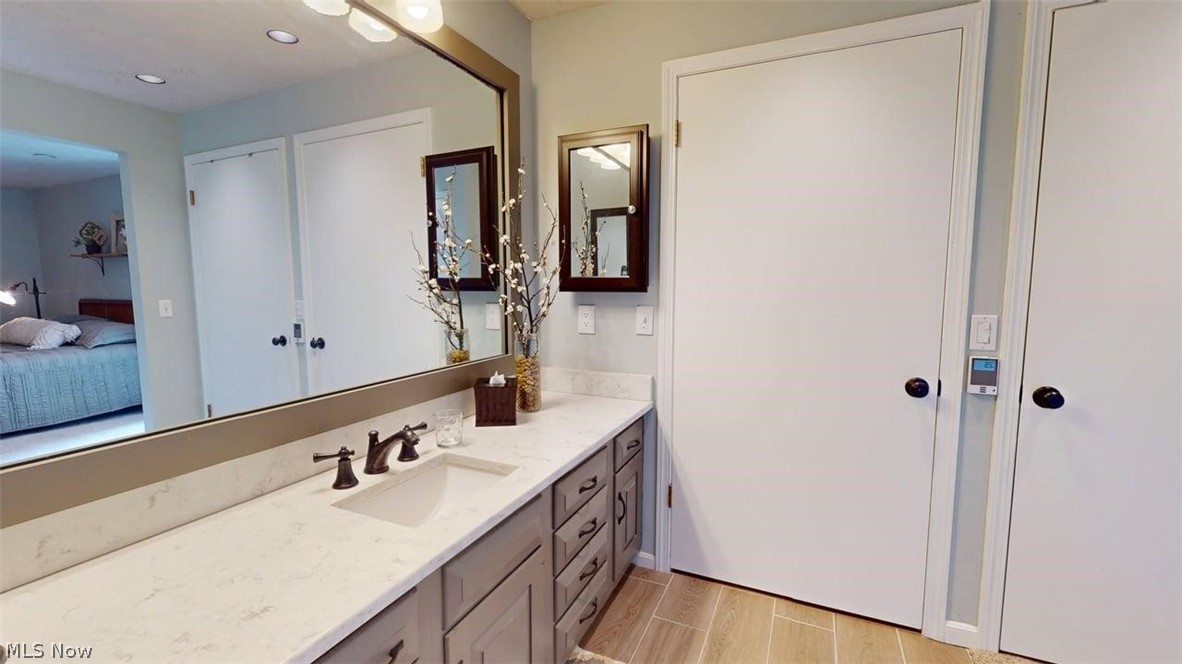 3985 Wiers Road Willard, OH 44890 - Photo 27 of 50 Bathroom vanity featuring a single undermount sink, dark bronze-finish faucet, and a light-toned countertop