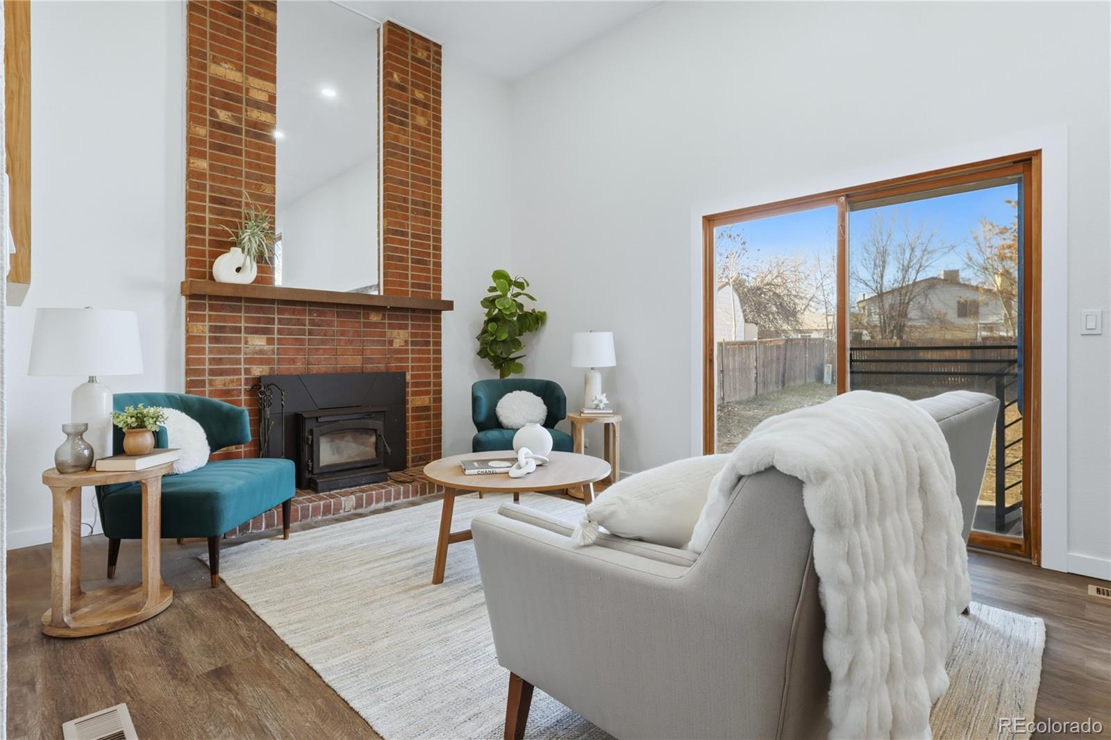 3173 South Nucla Street Aurora, CO 80013 - Photo 14 of 34 a living room with furniture and a fireplace