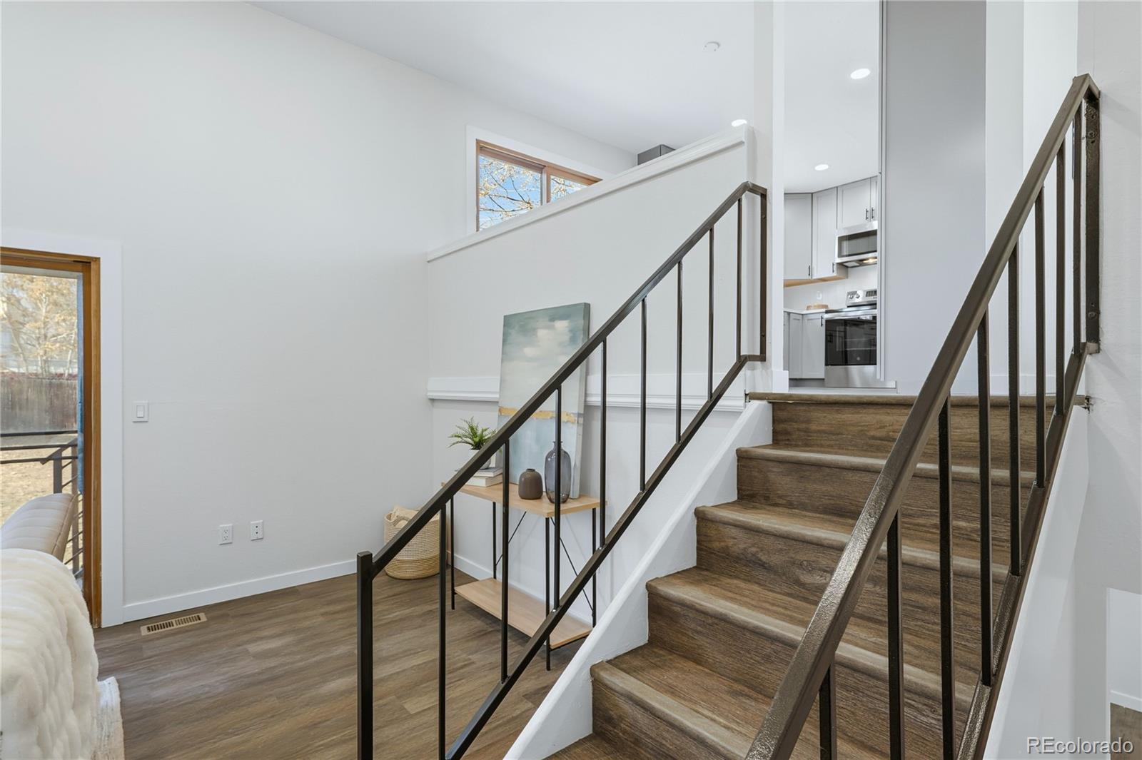 3173 South Nucla Street Aurora, CO 80013 - Photo 16 of 34 a view of staircase with wooden floor and white walls