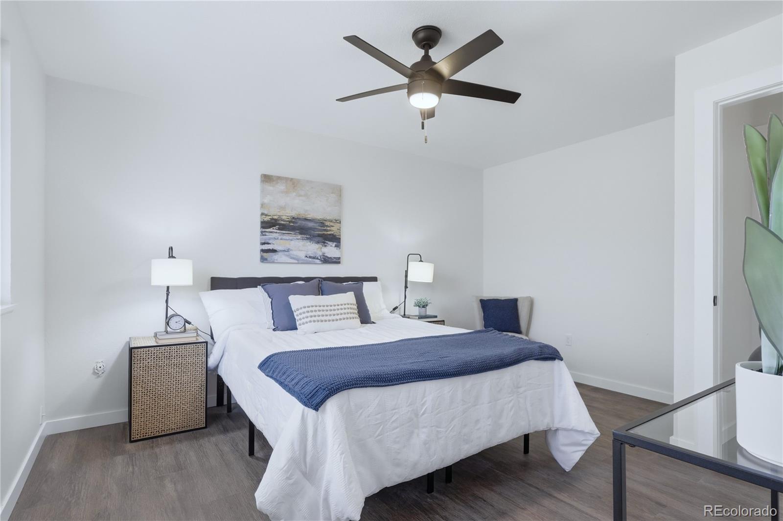 3173 South Nucla Street Aurora, CO 80013 - Photo 18 of 34 a bed room with a bed and a chandelier