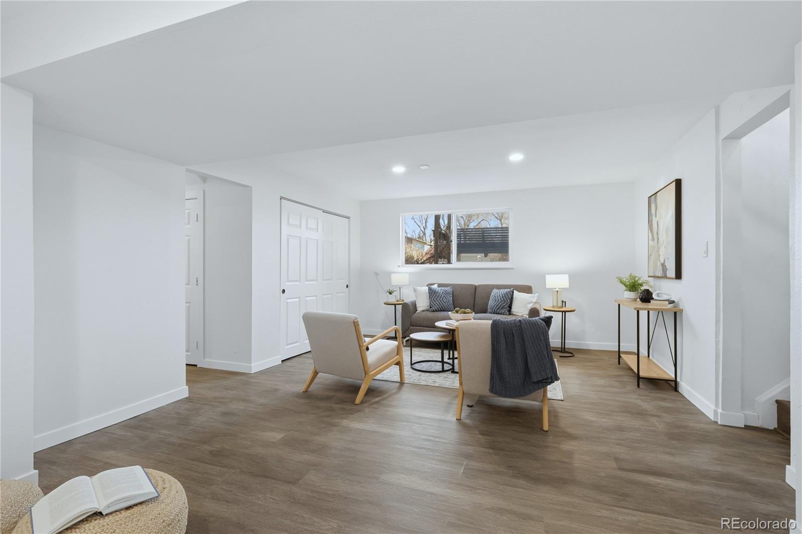 3173 South Nucla Street Aurora, CO 80013 - Photo 23 of 34 a living room with furniture and a wooden floor