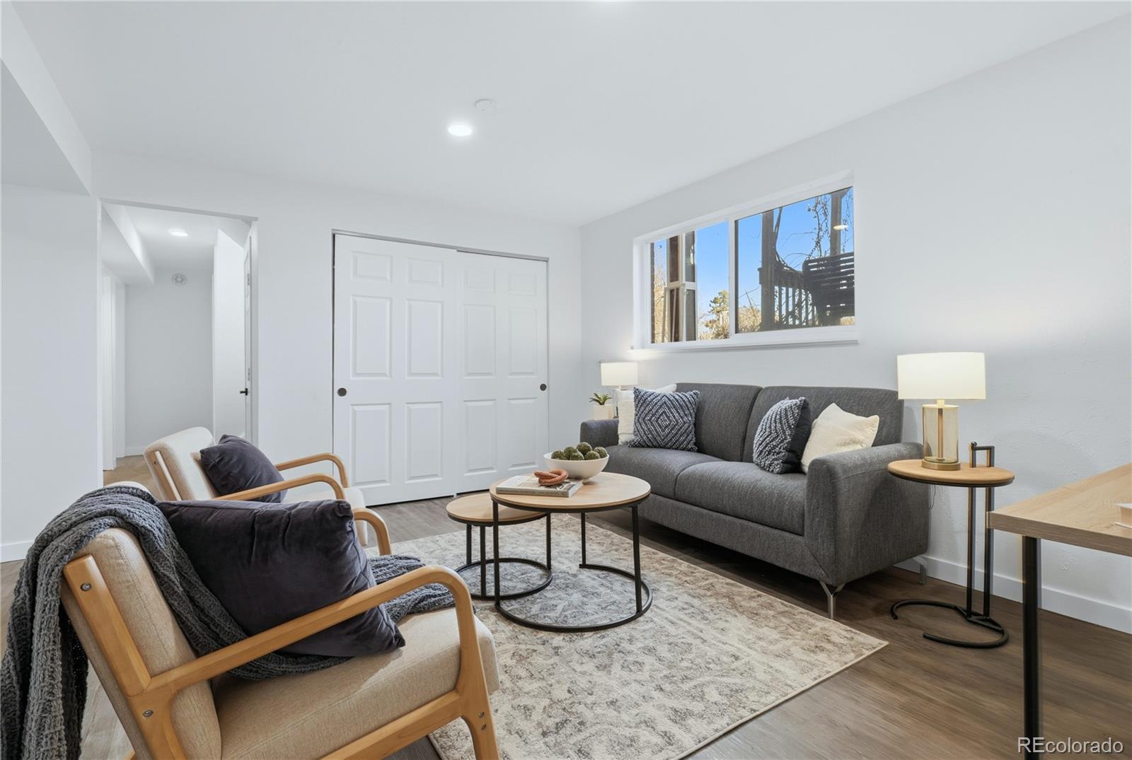 3173 South Nucla Street Aurora, CO 80013 - Photo 25 of 34 a living room with furniture a rug and a lamp
