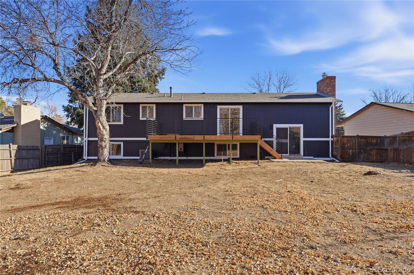 3173 South Nucla Street Aurora, CO 80013 - Photo 31 of 34 a front view of a house with a yard and garage