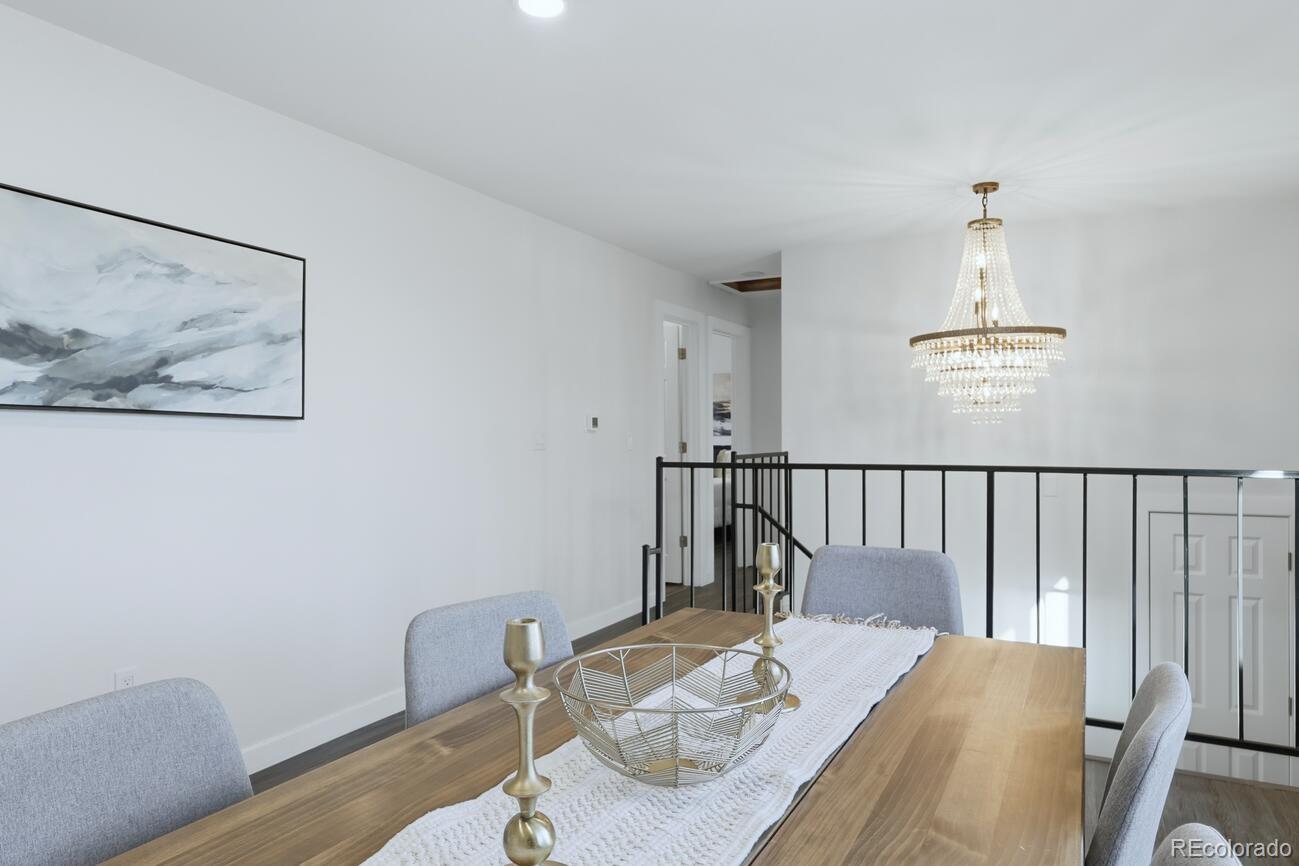 3173 South Nucla Street Aurora, CO 80013 - Photo 4 of 34 a view of a dining room with furniture wooden floor and a chandelier
