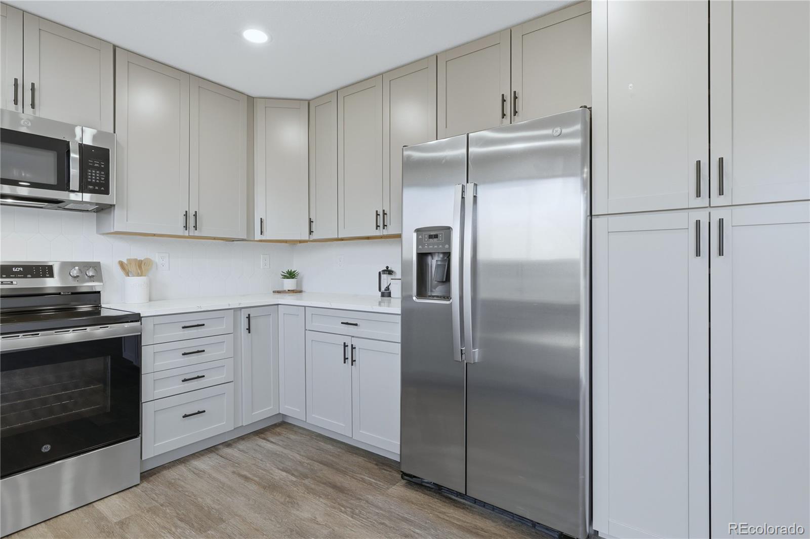 3173 South Nucla Street Aurora, CO 80013 - Photo 10 of 34 a kitchen with cabinets stainless steel appliances and a sink