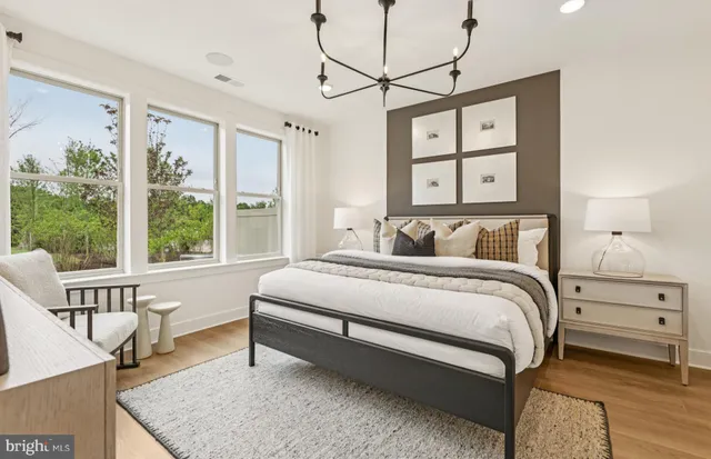 a bedroom with a bed window and couch