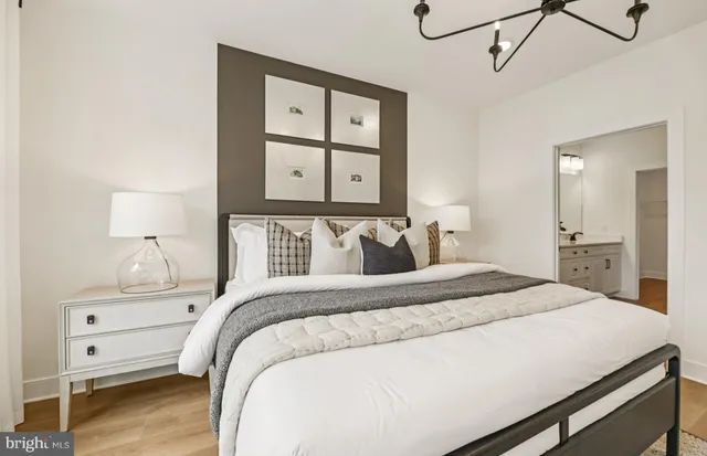 a bedroom with a bed and a night stand