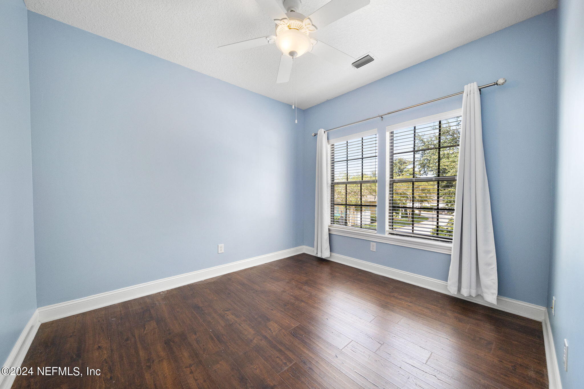 650 South Loop Parkway St. Augustine, FL 32095 - Photo 27 of 42 wooden floor in an empty room with a window