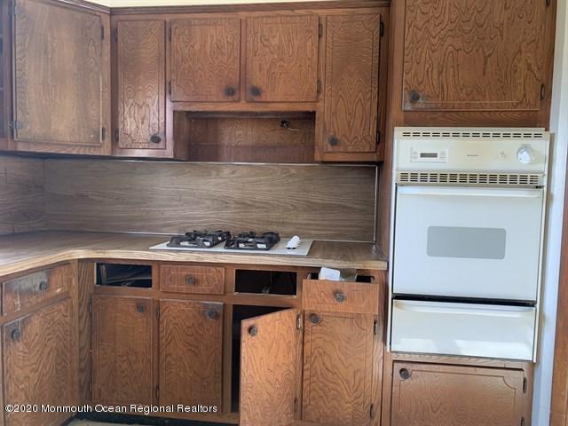 116 Oak Glen Road Howell, NJ 07731 - Photo 8 of 16 a kitchen with stainless steel appliances granite countertop cabinets and a counter top space