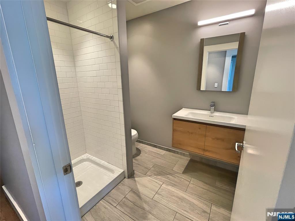 58 New Street, Unit 3D Newark, NJ 07102 - Photo 2 of 7 a bathroom with a sink and a mirror