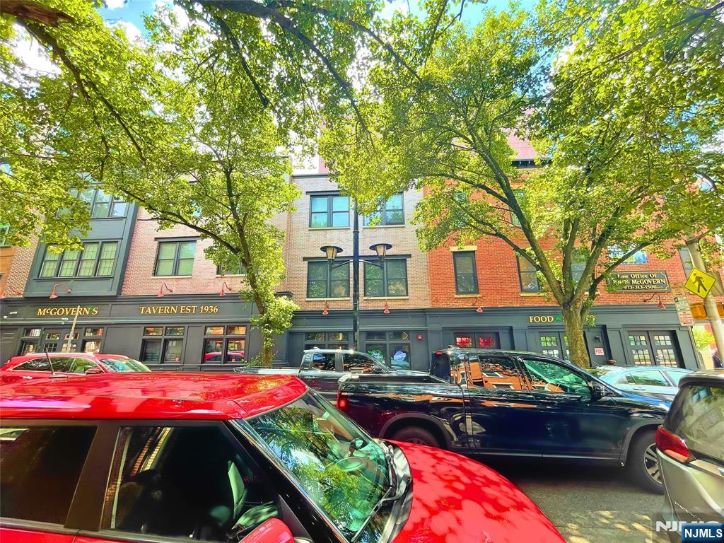 58 New Street, Unit 3D Newark, NJ 07102 - Photo 7 of 7 a front view of a house with yard and furniture