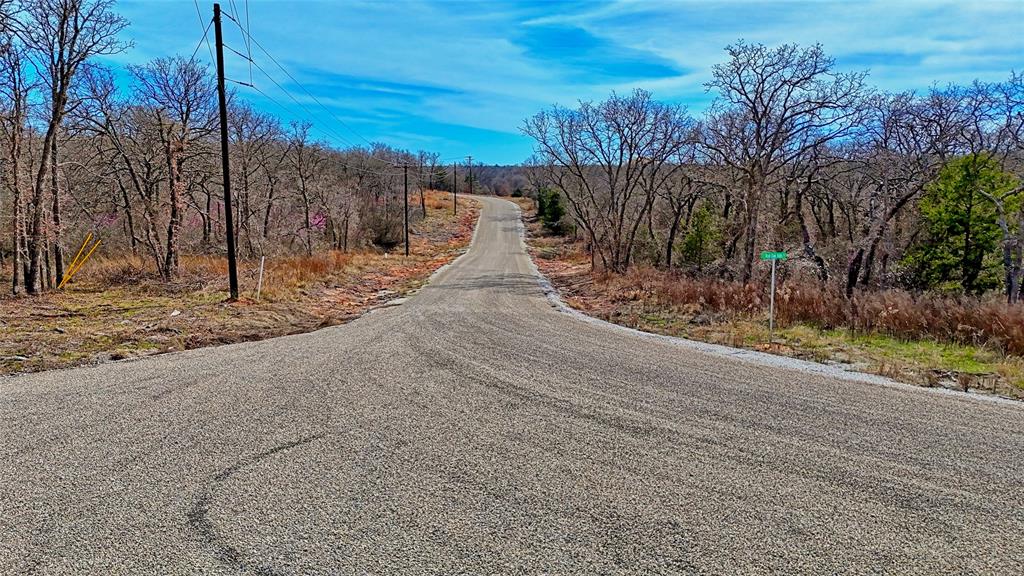 1887 Red Oak Hills Road Nocona, TX 76255 - Photo 10 of 32 a view of a yard with wooden fence