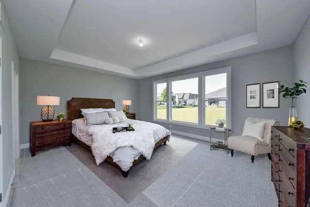 a bedroom with bed and large window