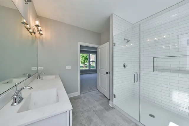 a bathroom with a sink a shower and a mirror