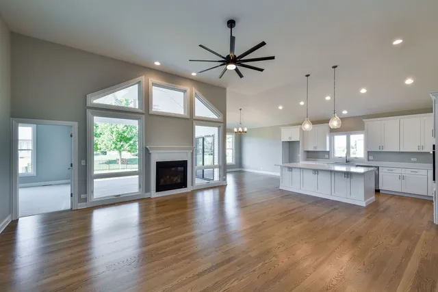 an open kitchen view with fireplace and wooden floor