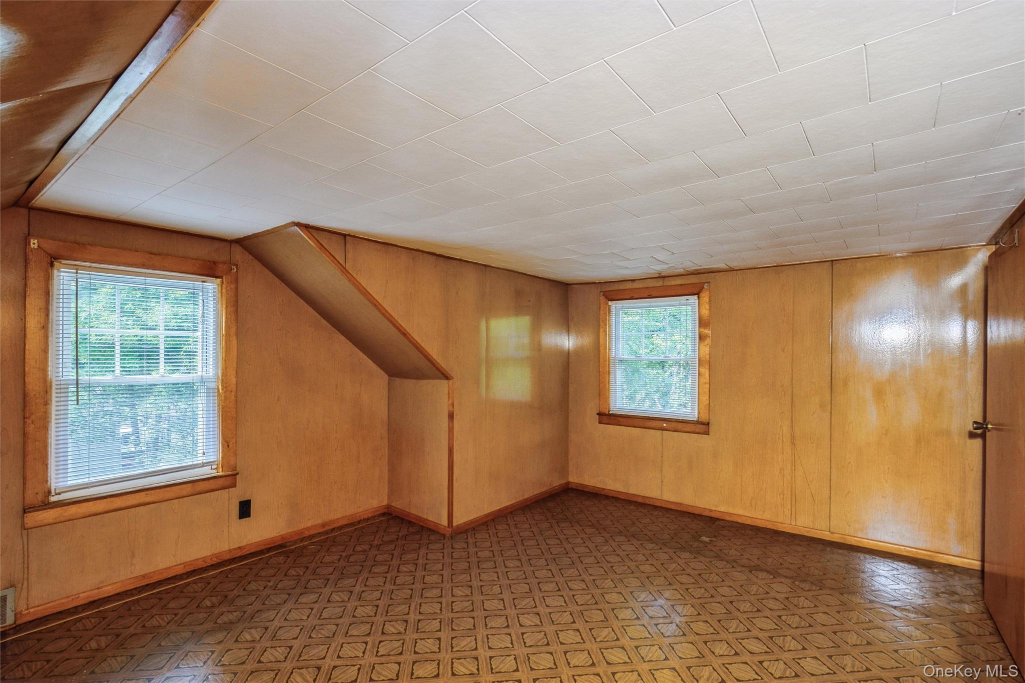 10 Laurel Road Ronkonkoma, NY 11779 - Photo 13 of 21 a view of an empty room with window and wooden floor