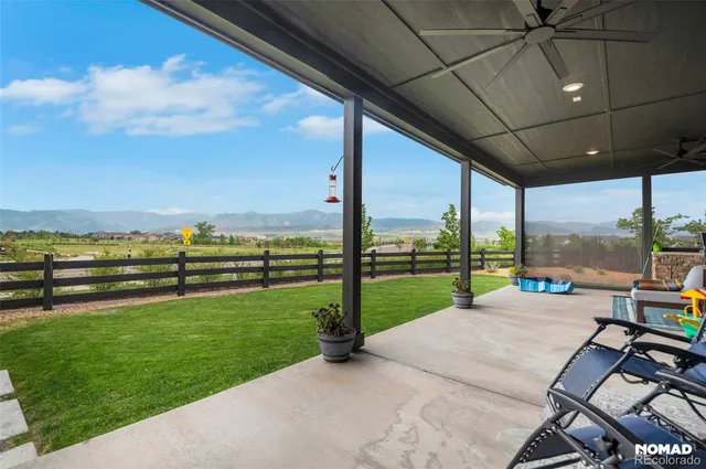a view of a patio with a table chairs and garden