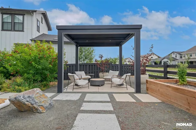 a view of a patio with couches chairs and a floor to ceiling window