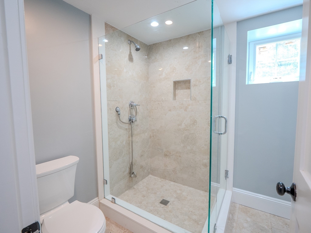 159 Mishawum Road Woburn, MA 01801 - Photo 27 of 41 a bathroom with a shower a toilet and a sink