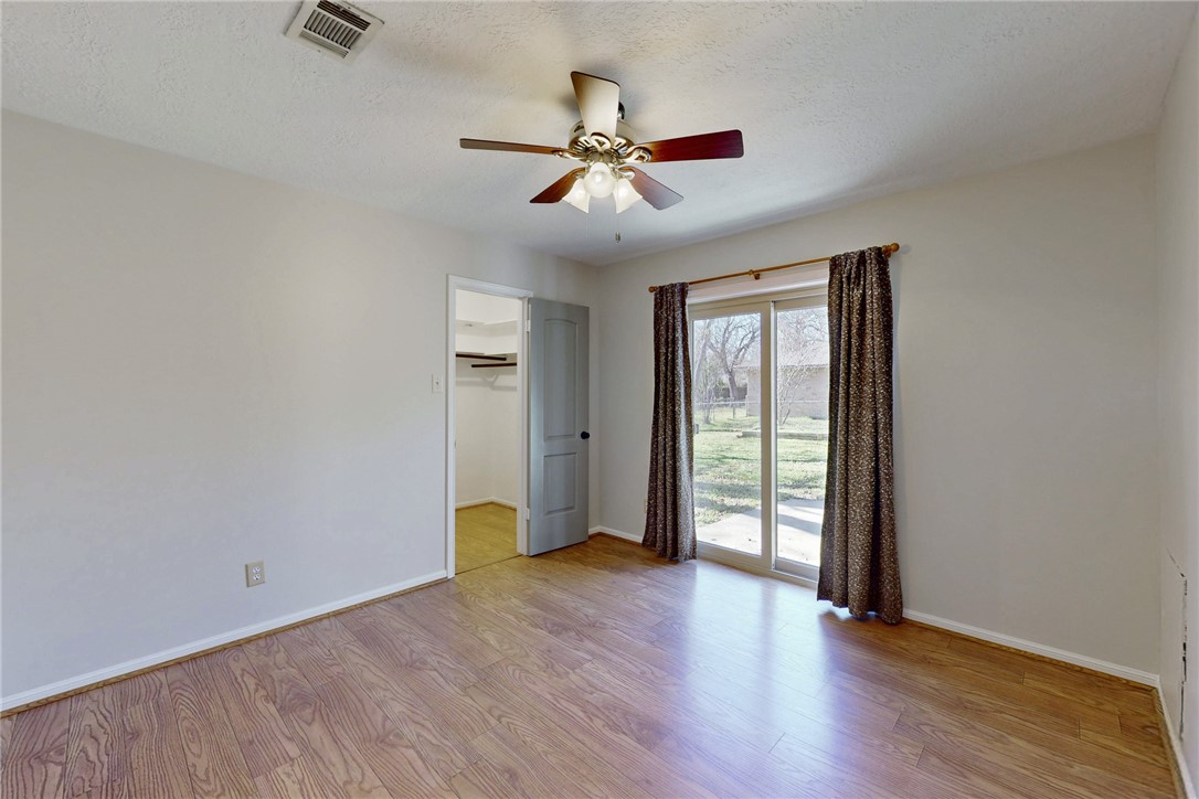 1308 Hawk Tree Drive College Station, TX 77845 - Photo 18 of 34 wooden floor in an empty room with a window