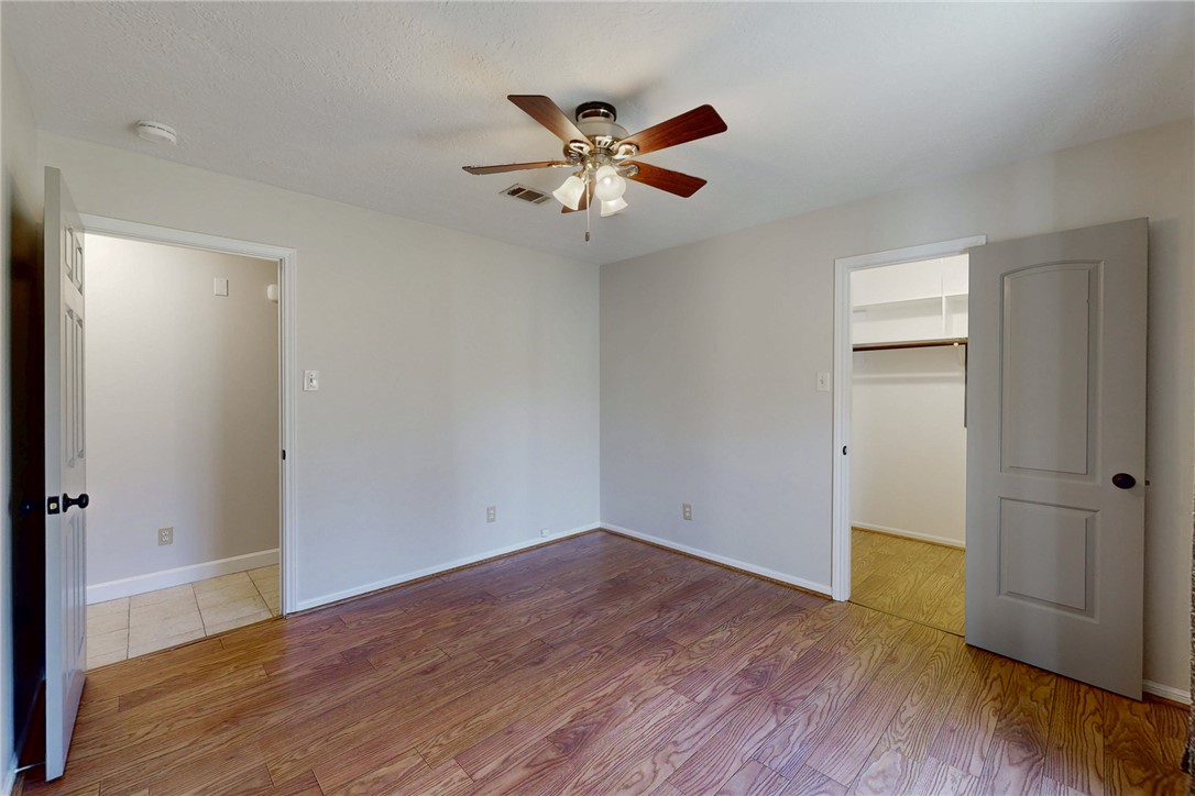 1308 Hawk Tree Drive College Station, TX 77845 - Photo 19 of 34 a view of empty room with wooden floor and ceiling fan