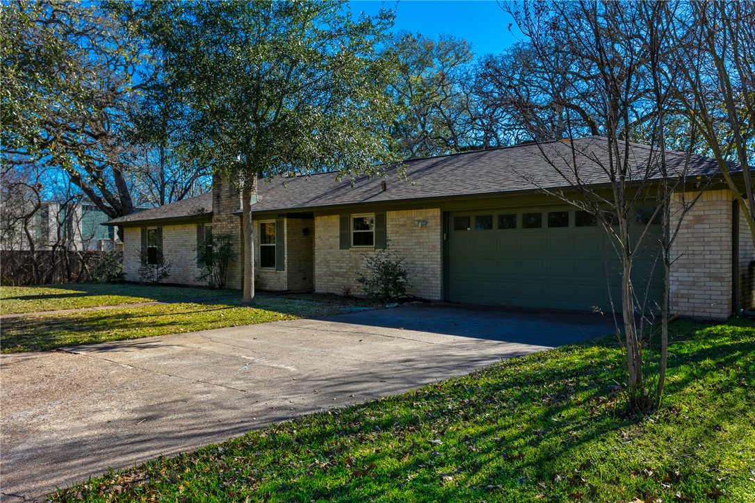 1308 Hawk Tree Drive College Station, TX 77845 - Photo 2 of 34 a front view of a house with a yard and trees