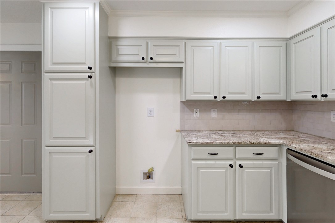 1308 Hawk Tree Drive College Station, TX 77845 - Photo 7 of 34 a kitchen with white cabinets and a sink