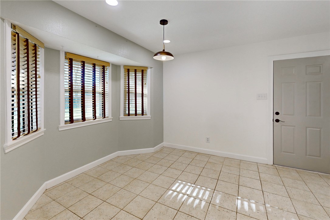1308 Hawk Tree Drive College Station, TX 77845 - Photo 9 of 34 a view of an empty room with window and chandelier fan