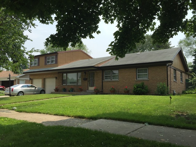 5925 107th Street Chicago Ridge, IL 60415 - Photo 1 of 21 a front view of a house with a yard and garage