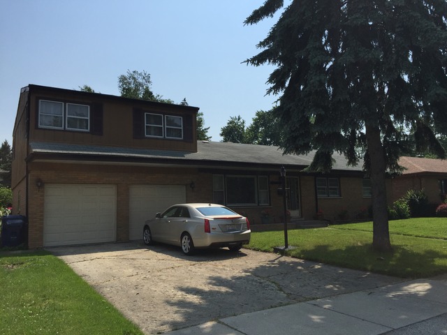 5925 107th Street Chicago Ridge, IL 60415 - Photo 18 of 21 a car parked in front of a house with a yard
