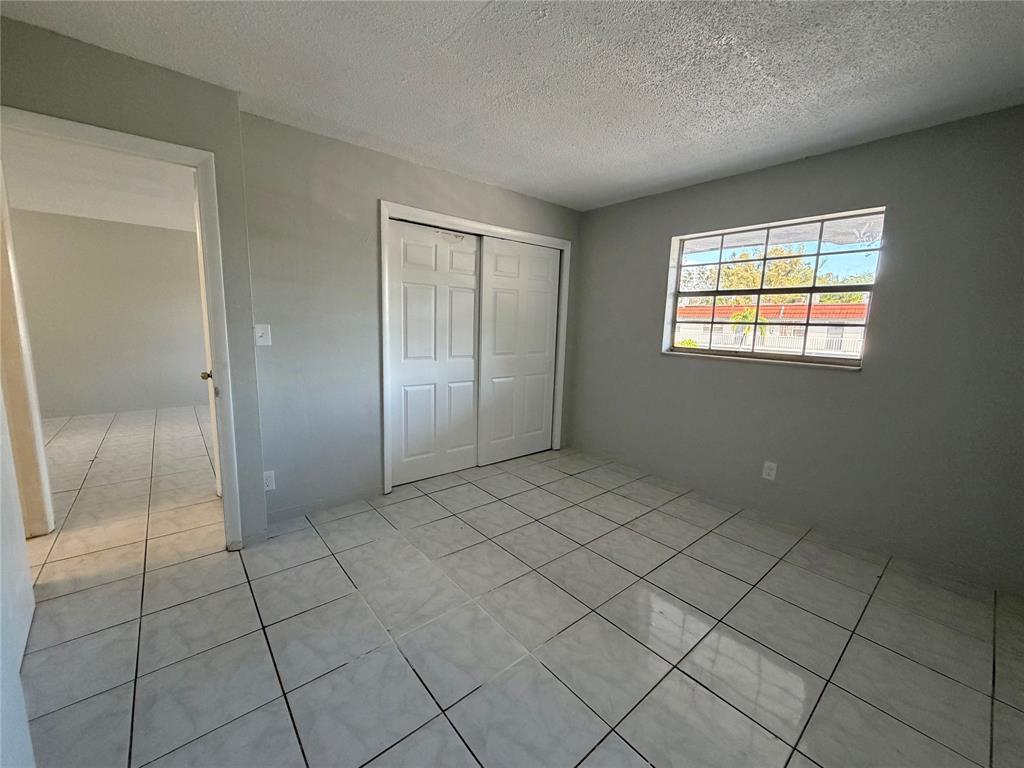 874 Southwest 10th Drive, Unit 741216 Pompano Beach, FL 33060 - Photo 15 of 16 a view of an empty room and window