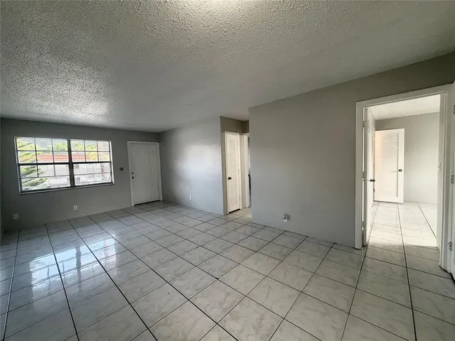 an empty room with windows and entrance