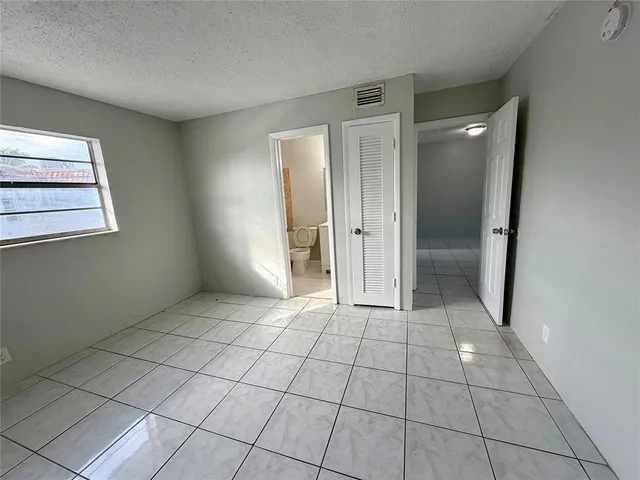 a view of a livingroom with an empty space and a window