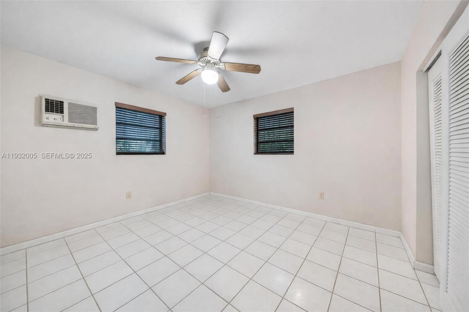 8230 Southwest 117th Terrace Miami, FL 33156 - Photo 9 of 18 a view of an empty room with a window