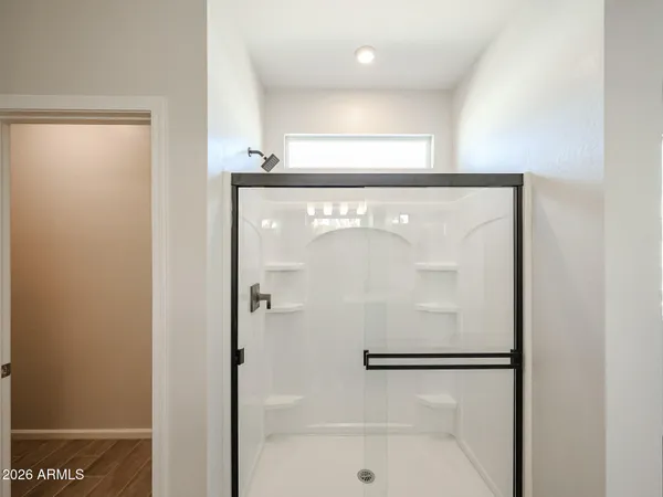 a bathroom with a glass shower door