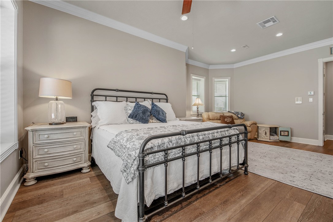 6045 Old Reliance Road Bryan, TX 77808 - Photo 16 of 50 a bedroom with a bed and a night stand