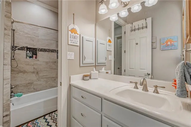 a bathroom with a tub sink and mirror