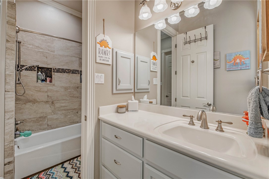 6045 Old Reliance Road Bryan, TX 77808 - Photo 17 of 50 a bathroom with a tub sink and mirror