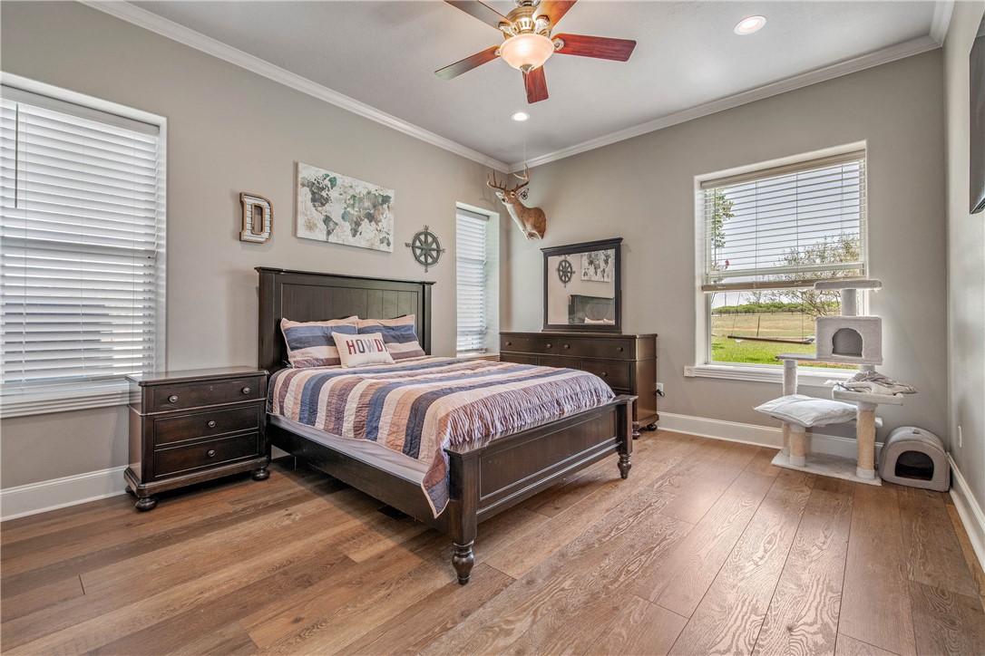 6045 Old Reliance Road Bryan, TX 77808 - Photo 18 of 50 a bedroom with a bed and a chandelier