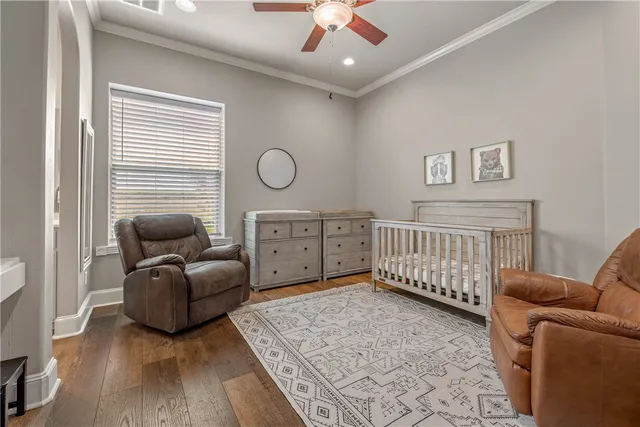 a bedroom with furniture and wooden floor