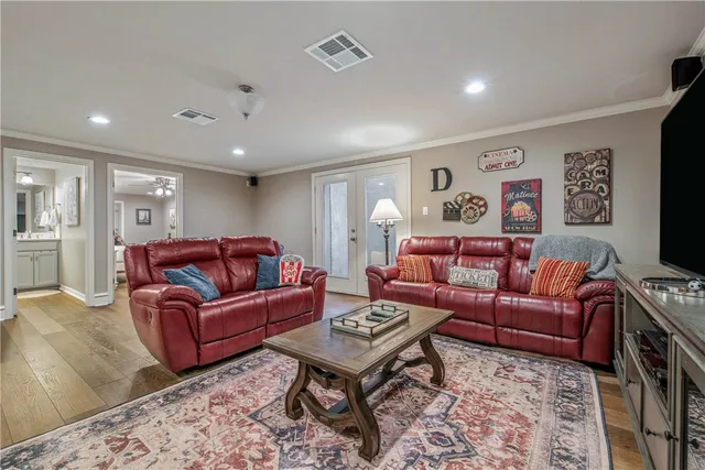 a living room with furniture a rug and a flat screen tv