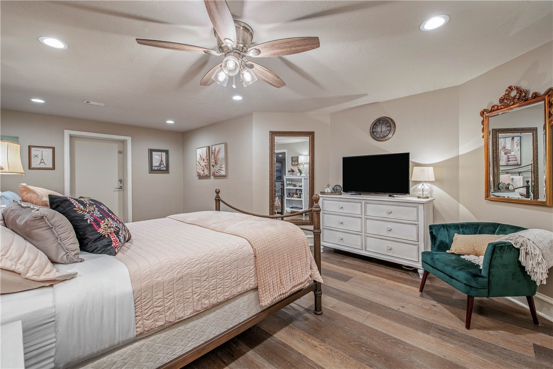 6045 Old Reliance Road Bryan, TX 77808 - Photo 25 of 50 a bedroom with a bed and a flat screen tv